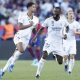 Real Madrid's midfielder Jude Bellingham (L) jubilates with his teammate Antonio Rudiger
