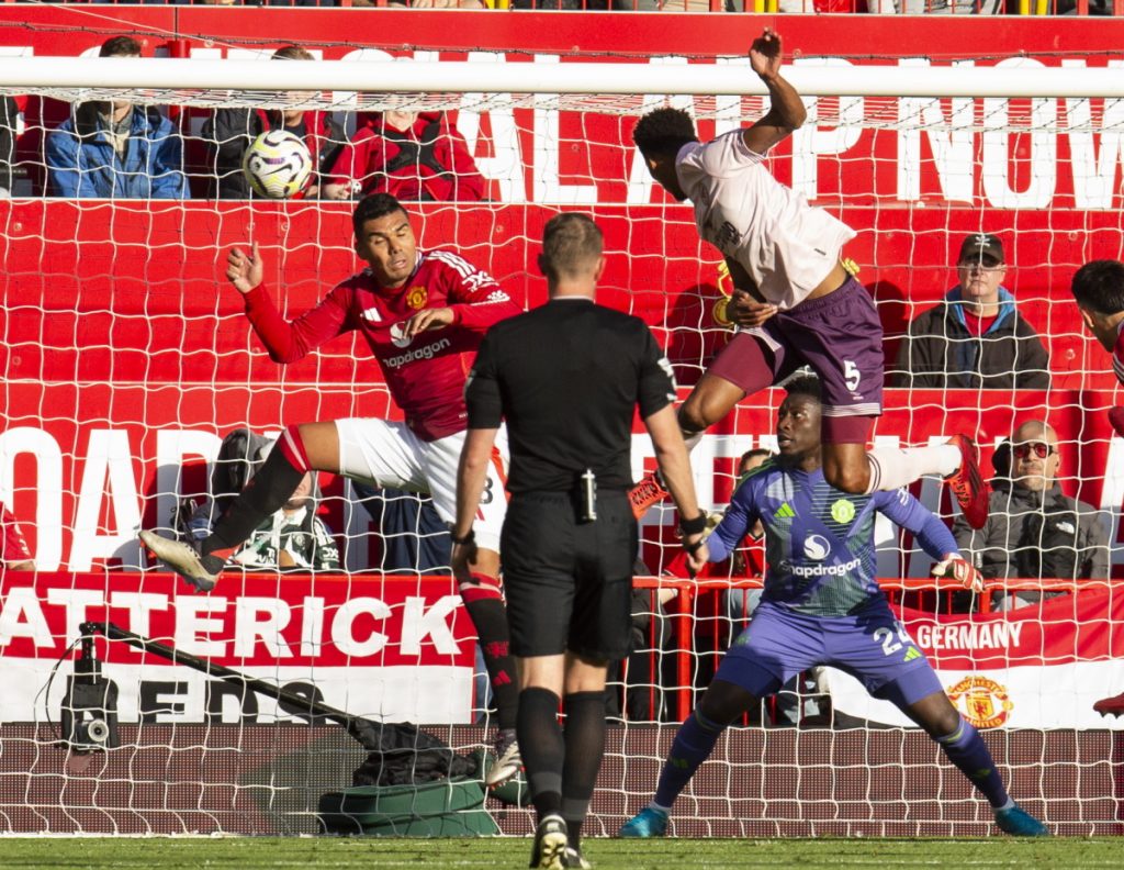 Ethan Pinnock of Brentford scores against Manchester United