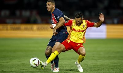 Lucas Hernandez of PSG (L) in action against Adrien Thomasson of Lens