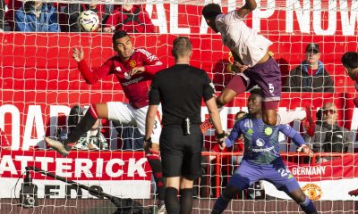 Ethan Pinnock of Brentford scores against Manchester United