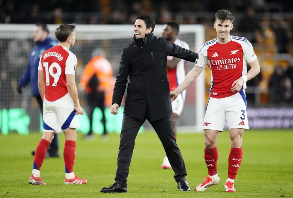 Arsenal manager Mikel Arteta (centre) and Kieran Tierney after the Premier League match at Molineux Stadium, Wolverhampton.