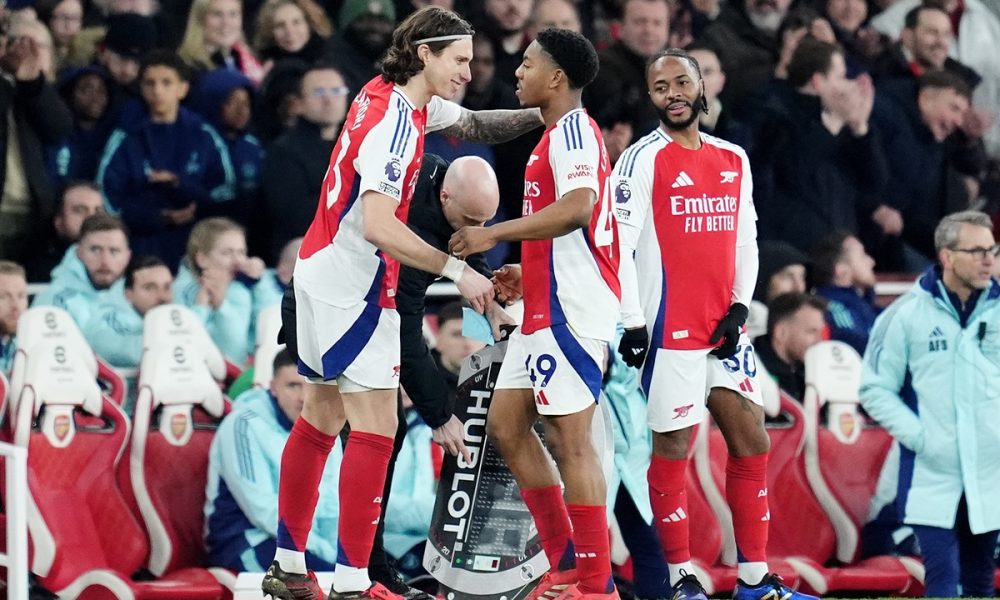 Arsenal's Myles Lewis-Skelly (centre right) is replaced by substitute Arsenal's Riccardo Calafiori (left) during the Premier League match at the Emirates Stadium, London. Picture date: Sunday February 2, 2025.