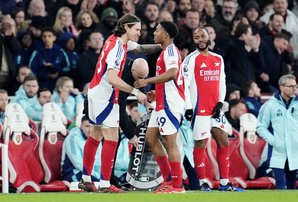 Arsenal's Myles Lewis-Skelly (centre right) is replaced by substitute Arsenal's Riccardo Calafiori (left) during the Premier League match at the Emirates Stadium, London. Picture date: Sunday February 2, 2025.