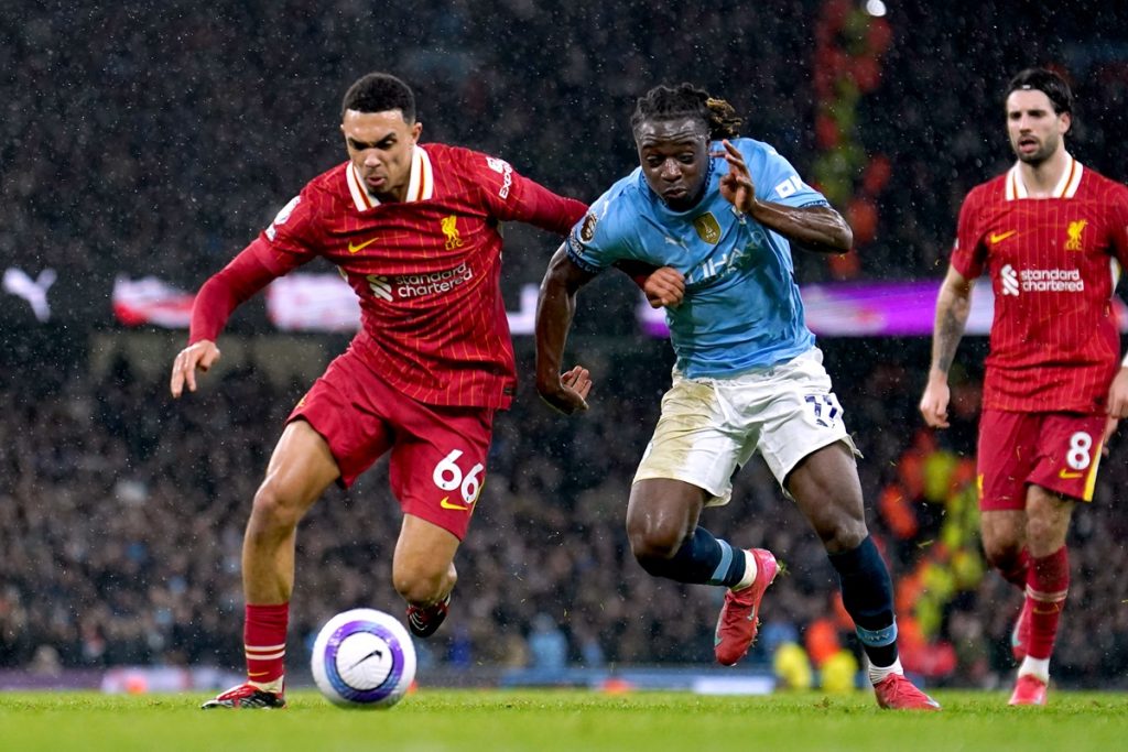 Liverpool's Trent Alexander-Arnold (left) battle for the ball with Manchester City's Jeremy Doku during the Premier League match at the Etihad Stadium, Manchester. Picture date: Sunday February 23, 2025.