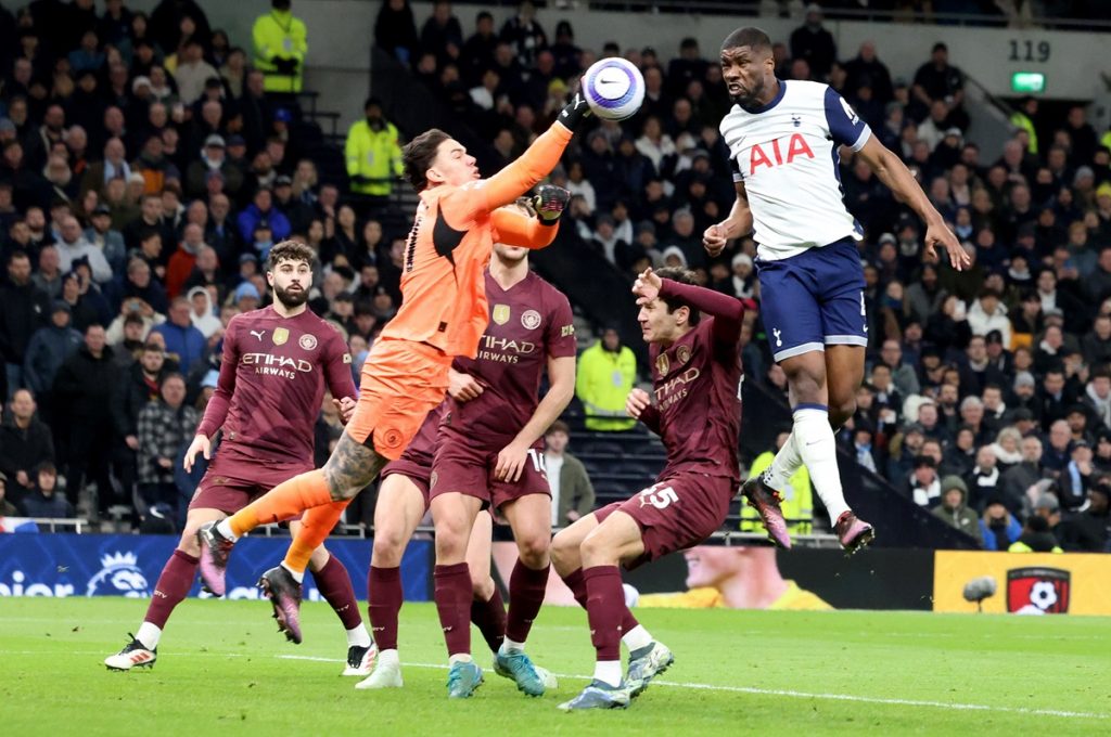 epa11926445 Manchester City goalkeeper punches the ball ahead of Tottenham Hotspur player Kevin Danso (R) during the English Premier League match between Tottenham Hotspur and Manchester City, in London, Britain, 26 February 2025. EPA/NEIL HALL EDITORIAL USE ONLY. No use with unauthorized audio, video, data, fixture lists, club/league logos, 'live' services or NFTs. Online in-match use limited to 120 images, no video emulation. No use in betting, games or single club/league/player publications.