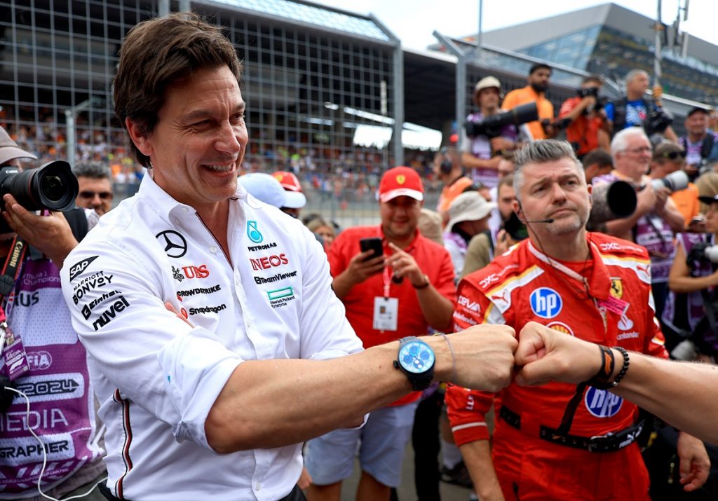 epa11447516 Mercedes team principal Toto Wolff is being congratulated after their driver George Russell of Britain won the Formula One Austrian Grand Prix, in Spielberg, Austria, 30 June 2024. Person 2nd R is unidentified staff of Mercedes team. EPA/MARTIN DIVISEK