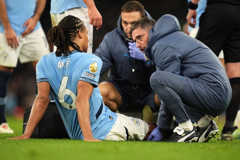 Manchester City's Nathan Ake is attended to by medical staff during the Premier League match at the Etihad Stadium, Manchester. Picture date: Wednesday December 4, 2024.